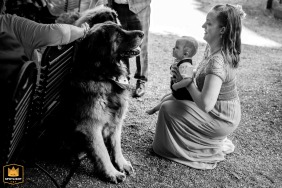 Mother and baby meet a wedding guest at Schloss Friedewald, Hessen, Germany, captured in a warm, candid moment.